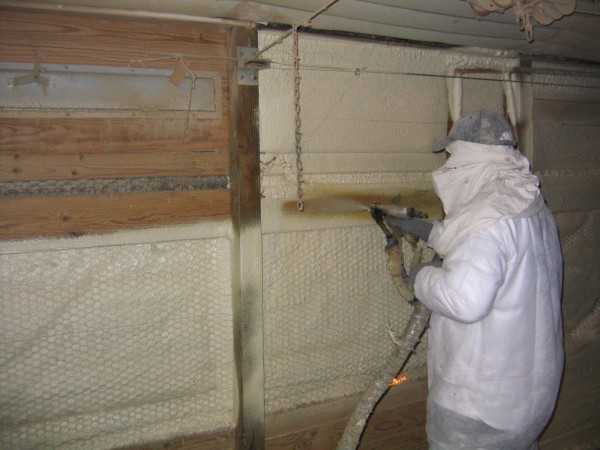 spraying urethane in a chicken house